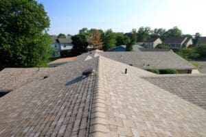 Aerial view of beige shingled roof ridge