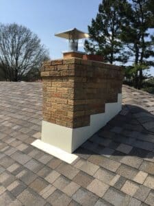New metal chimney flashing on shingle roof