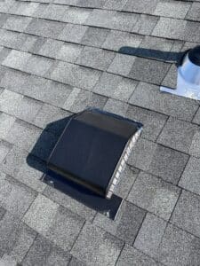 New roof vent installed on gray shingles