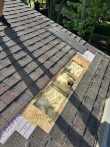 A set of dirty, weathered window screens placed on a rooftop.