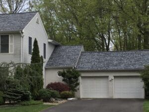 Suburban house with a two-car garage and well-maintained landscaping.