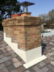 Brick chimney with cream metal flashing