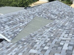 Gray shingle roof with patched valley section