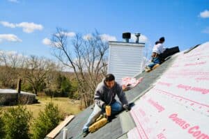 new jersey roofer nailing down roof shingles