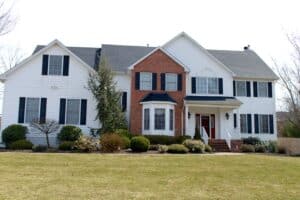 Two-story white colonial with gray roof