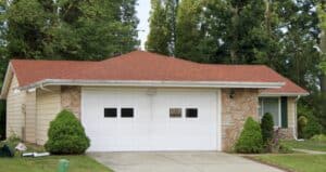 Suburban home with red shingle garage roof
