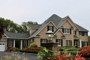 Brick mansion with lamp post and gardens